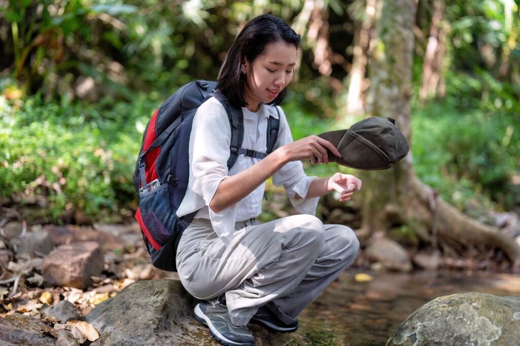 Backpack tourist travel hiking outdoor adventure use water stream from mountain washing hand