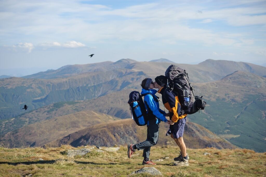 Couple hikers in the Carpathians mountains with backpacks