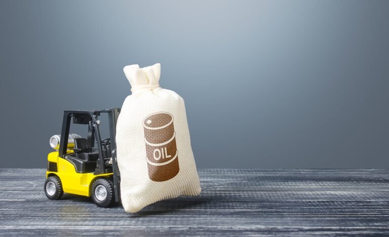 A forklift carries a bag with an oil barrel icon