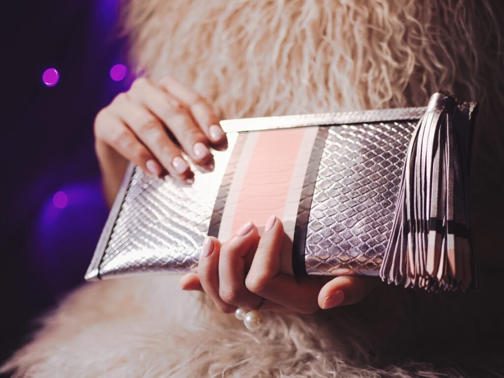 Female hands holding fashion clutch