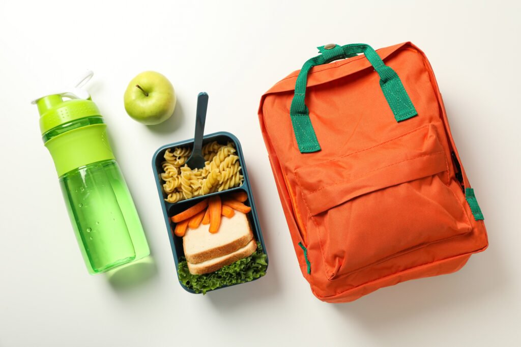 A school backpack with a lunch box with food
