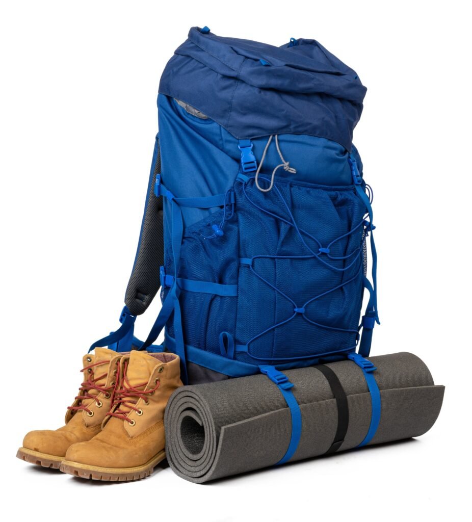Blue hiking backpack with fitness mat isolated on white