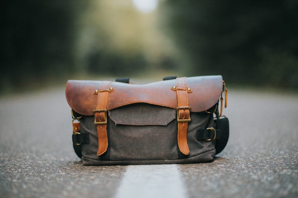 Closeup shot of a leather hiking bag on a road