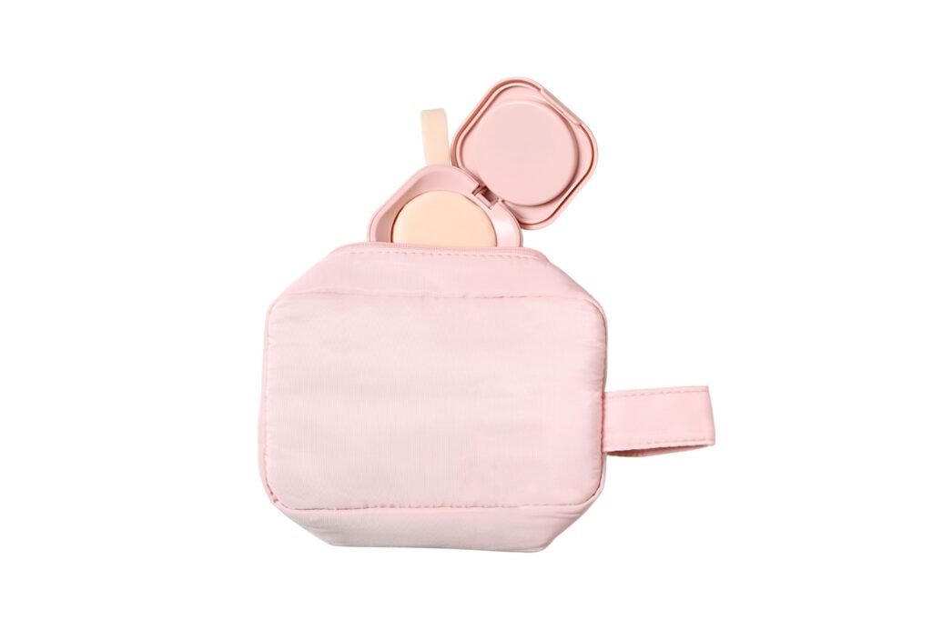 Pink makeup case with powder and applicator, isolated on white