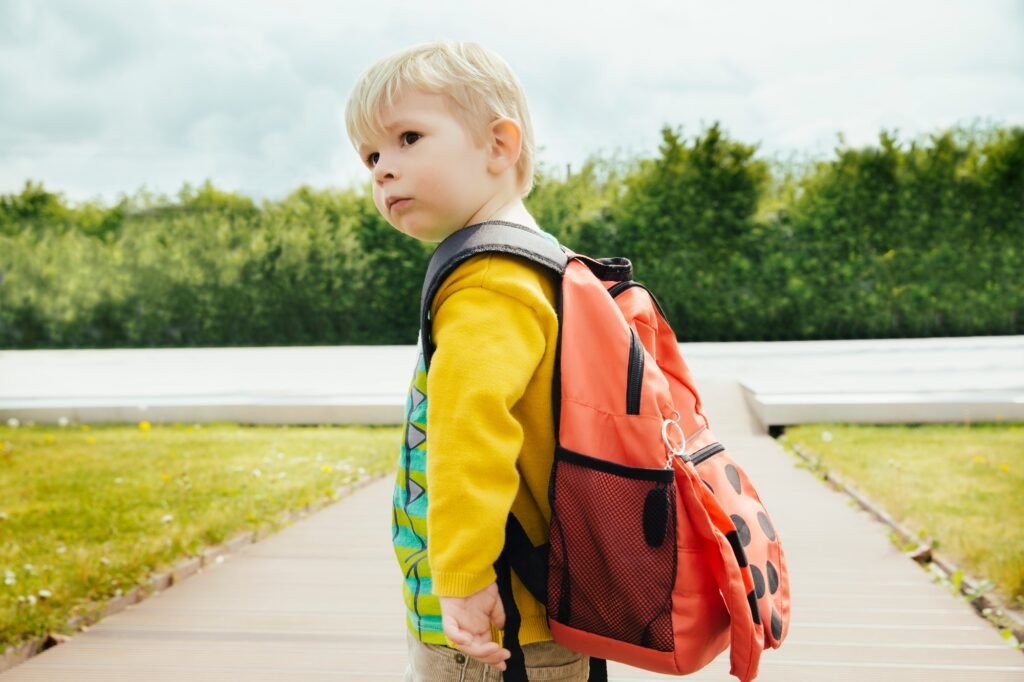 Toddler with backpack going to leave