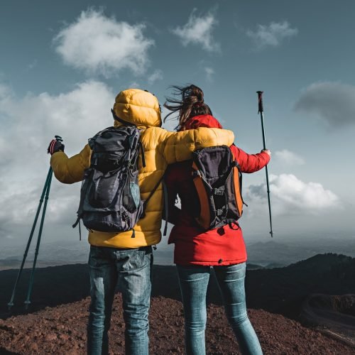 Back view of a couple of hikers with backpack